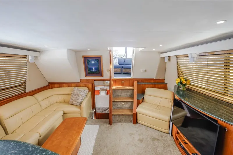 Just Joyce Yacht Photos Pics Luxurious interior of 2000 Silverton 435 yacht with beige seating and wooden accents.