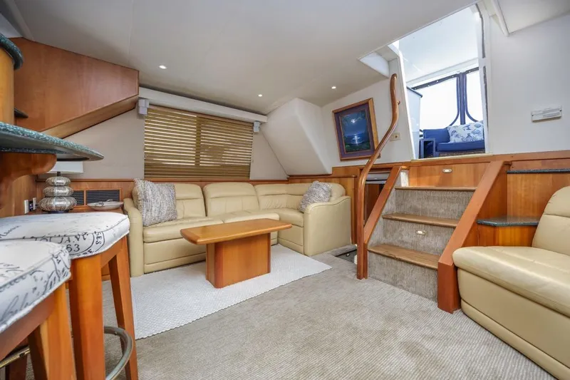 Just Joyce Yacht Photos Pics Luxurious interior of a 2000 Silverton 435 yacht with beige leather seating and wooden accents.