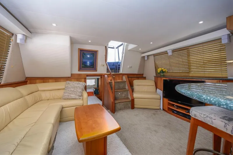 Just Joyce Yacht Photos Pics Luxurious interior of a 2000 Silverton 435 yacht with beige seating and modern amenities.