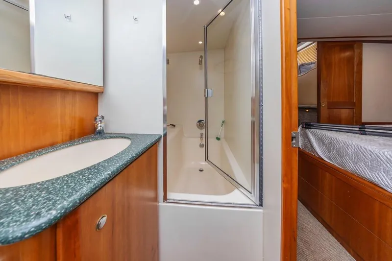 Just Joyce Yacht Photos Pics 2000 Silverton 435 yacht bathroom with sink, shower, and adjacent bedroom.