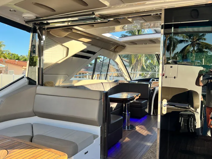 Day Off Yacht Photos Pics Luxurious interior of 2015 Regal 53 Sport Coupe yacht with modern seating and table.