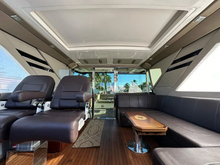 Day Off Yacht Photos Pics Luxurious interior of a 2015 Regal 53 Sport Coupe yacht with leather seating and wooden flooring.