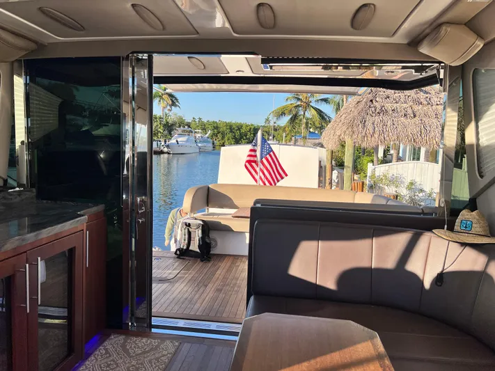 Day Off Yacht Photos Pics Interior view of 2015 Regal 53 Sport Coupe yacht with open deck and American flag.