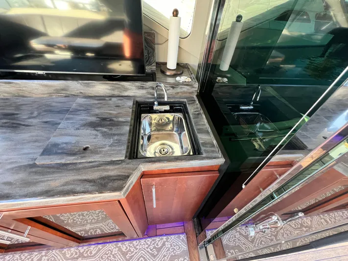 Day Off Yacht Photos Pics Luxurious interior of 2015 Regal 53 Sport Coupe with sleek sink and countertop.