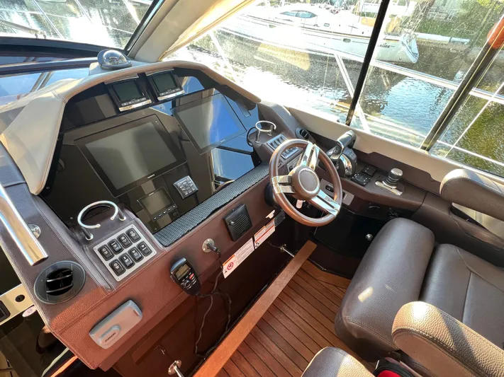 Day Off Yacht Photos Pics Interior cockpit of a 2015 Regal 53 Sport Coupe yacht with modern controls.