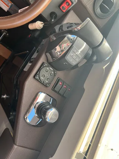Day Off Yacht Photos Pics Control panel of a 2015 Regal 53 Sport Coupe boat, featuring steering and navigation controls.