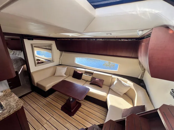 Day Off Yacht Photos Pics Luxurious interior of 2015 Regal 53 Sport Coupe yacht with elegant seating and wooden flooring.