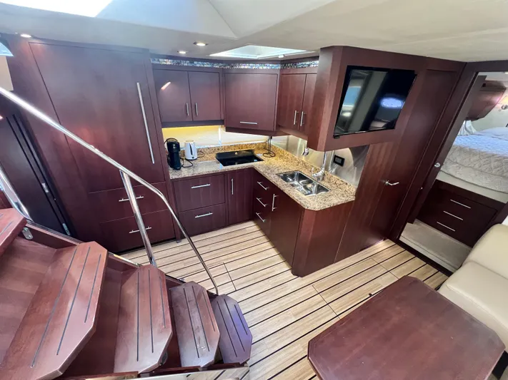 Day Off Yacht Photos Pics Luxurious 2015 Regal 53 Sport Coupe yacht interior with modern kitchen and elegant wood finishes.