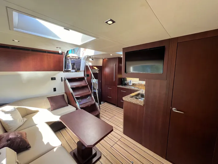 Day Off Yacht Photos Pics Luxurious interior of 2015 Regal 53 Sport Coupe with modern kitchen and seating area.