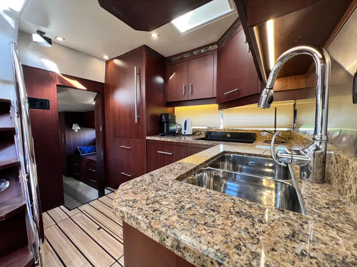 Day Off Yacht Photos Pics Luxurious kitchen interior of 2015 Regal 53 Sport Coupe yacht with granite countertops.