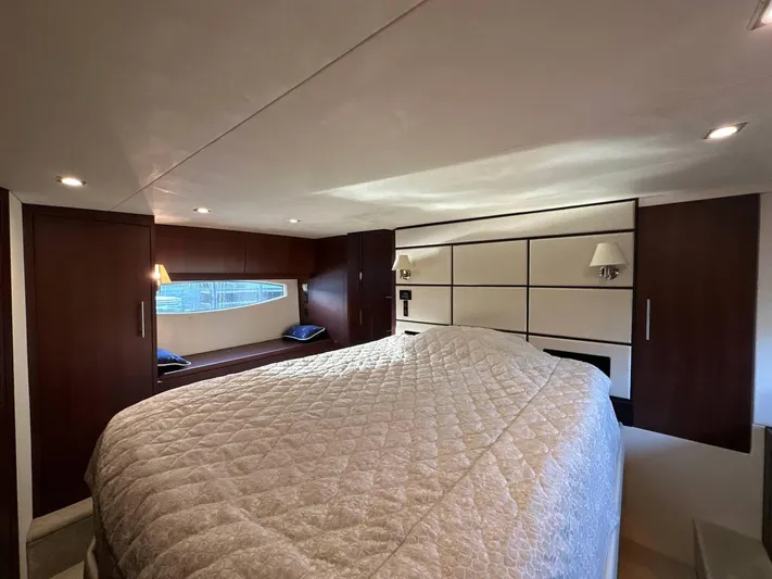 Day Off Yacht Photos Pics Luxurious bedroom interior of 2015 Regal 53 Sport Coupe yacht with elegant wood paneling.
