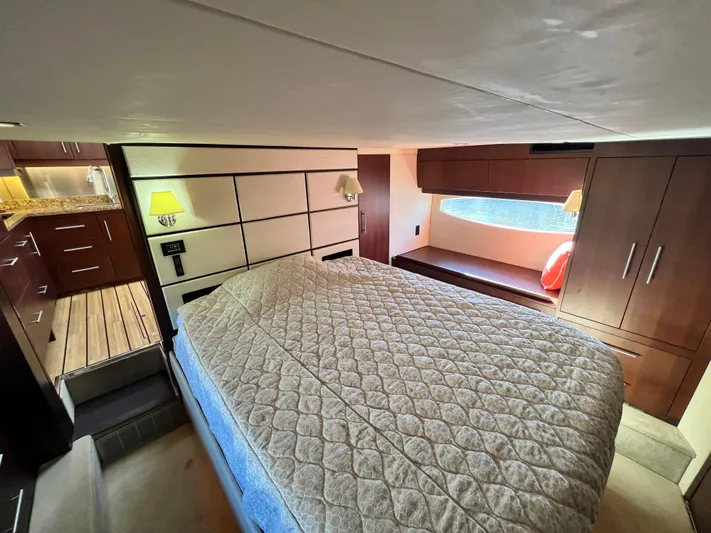 Day Off Yacht Photos Pics Luxurious interior of 2015 Regal 53 Sport Coupe with cozy bed and elegant wood finishes.