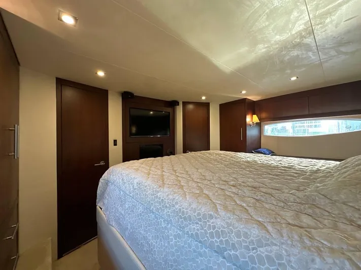 Day Off Yacht Photos Pics Luxurious bedroom interior of 2015 Regal 53 Sport Coupe yacht with elegant bedding and ambient lighting.