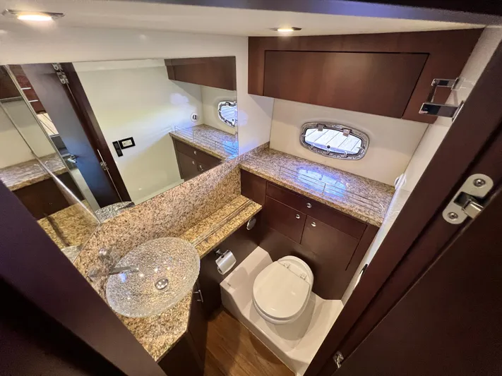 Day Off Yacht Photos Pics Luxurious bathroom in 2015 Regal 53 Sport Coupe with granite countertops and modern fixtures.