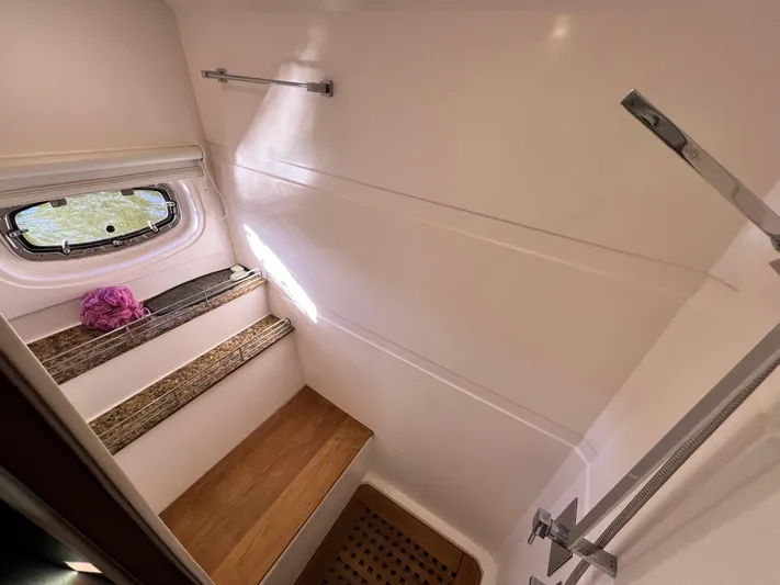 Day Off Yacht Photos Pics Interior of 2015 Regal 53 Sport Coupe shower with window and wooden accents.