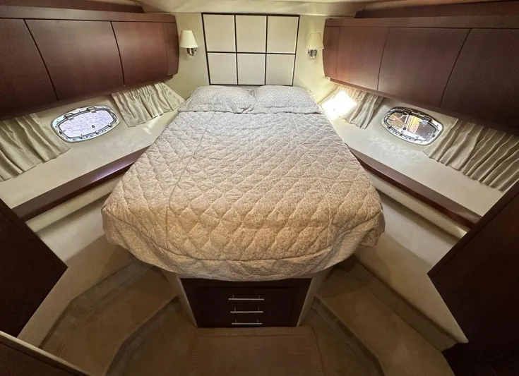 Day Off Yacht Photos Pics Luxurious cabin interior of 2015 Regal 53 Sport Coupe yacht with cozy bed and wooden cabinets.