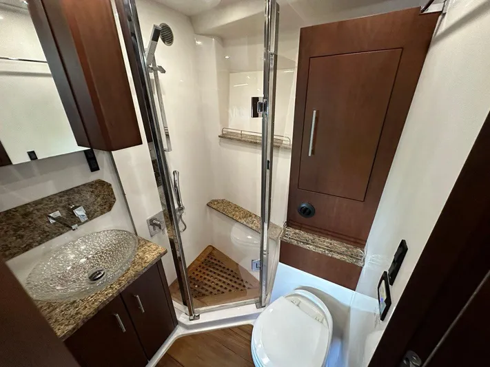 Day Off Yacht Photos Pics Luxurious bathroom in 2015 Regal 53 Sport Coupe yacht with glass sink and shower.