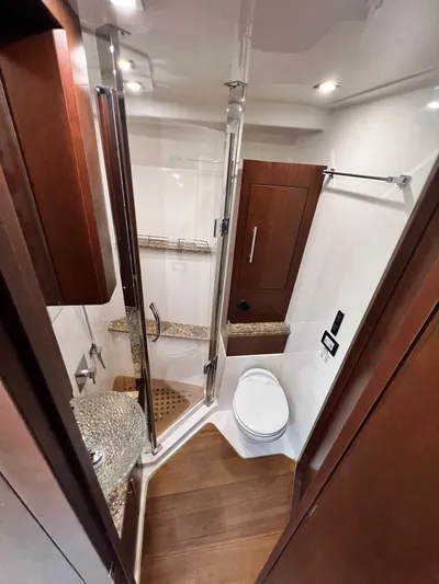 Day Off Yacht Photos Pics Luxurious bathroom in 2015 Regal 53 Sport Coupe yacht with modern fixtures and wood accents.