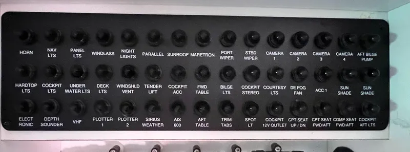 Day Off Yacht Photos Pics Control panel of a 2015 Regal 53 Sport Coupe with labeled switches and buttons.