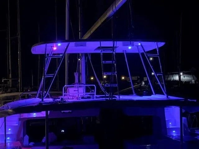 As You Wish Yacht Photos Pics 2020 Lagoon 46 catamaran illuminated with blue lights at night.