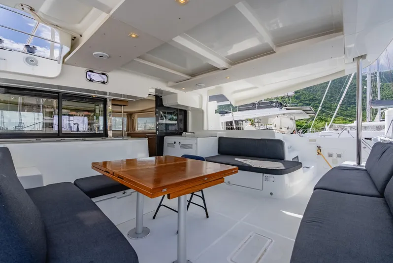 As You Wish Yacht Photos Pics Spacious interior of 2020 Lagoon 46 yacht with seating and table.