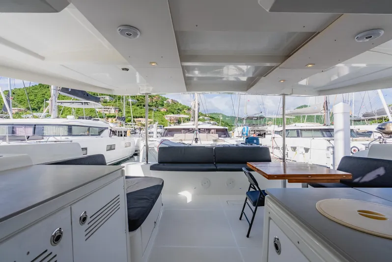 As You Wish Yacht Photos Pics Spacious interior of 2020 Lagoon 46 catamaran docked at marina with lush green backdrop.