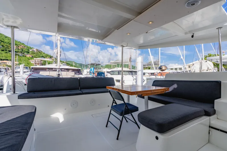 As You Wish Yacht Photos Pics Spacious outdoor seating on 2020 Lagoon 46 catamaran, docked at marina with scenic views.