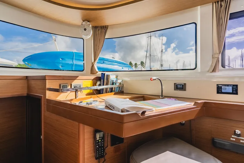 As You Wish Yacht Photos Pics Interior of 2020 Lagoon 46 yacht with navigation desk and panoramic windows.
