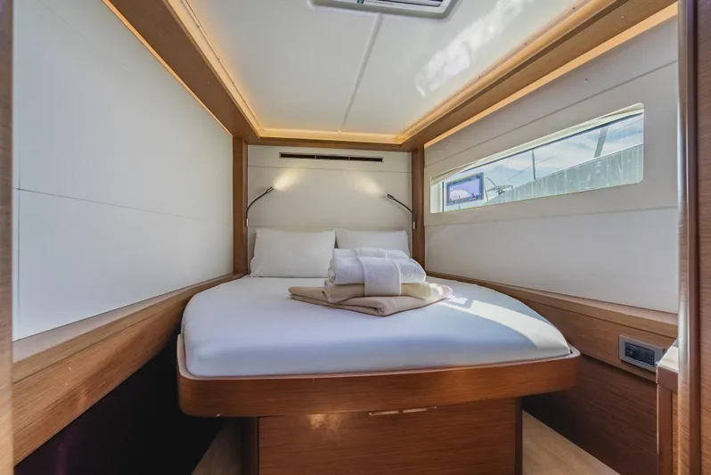 As You Wish Yacht Photos Pics Luxurious cabin interior of 2020 Lagoon 46 yacht with cozy bed and modern lighting.