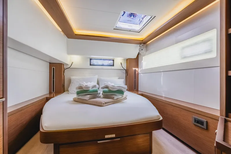 As You Wish Yacht Photos Pics Luxurious cabin interior of 2020 Lagoon 46 yacht with cozy bed and modern lighting.