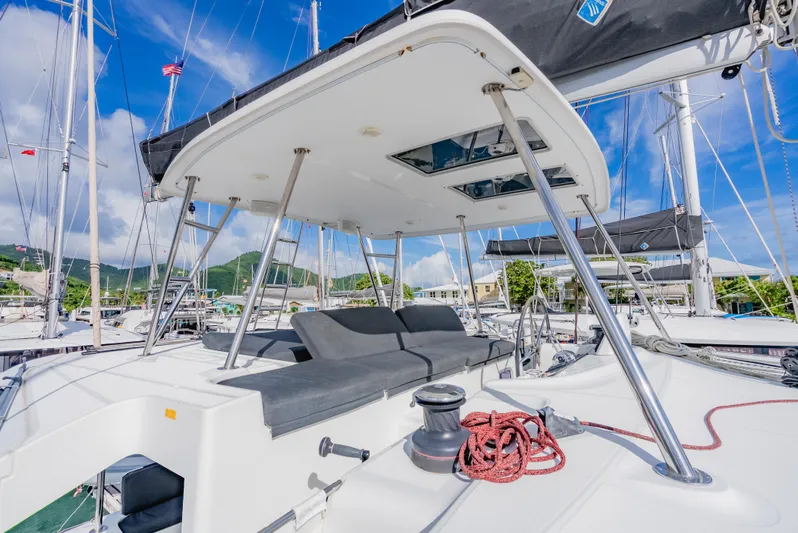 As You Wish Yacht Photos Pics 2020 Lagoon 46 catamaran deck with seating, winch, and ropes under a clear blue sky.