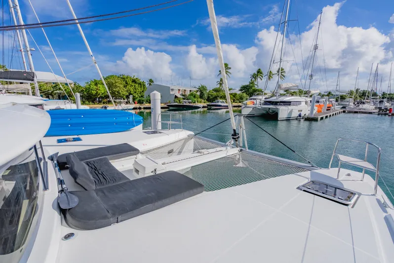 As You Wish Yacht Photos Pics Lagoon 46 catamaran docked in a marina, featuring spacious deck and seating, 2020 model.