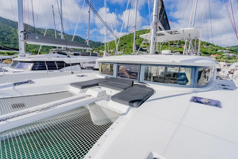 As You Wish Yacht Photos Pics 2020 Lagoon 46 catamaran with spacious deck and scenic marina backdrop.