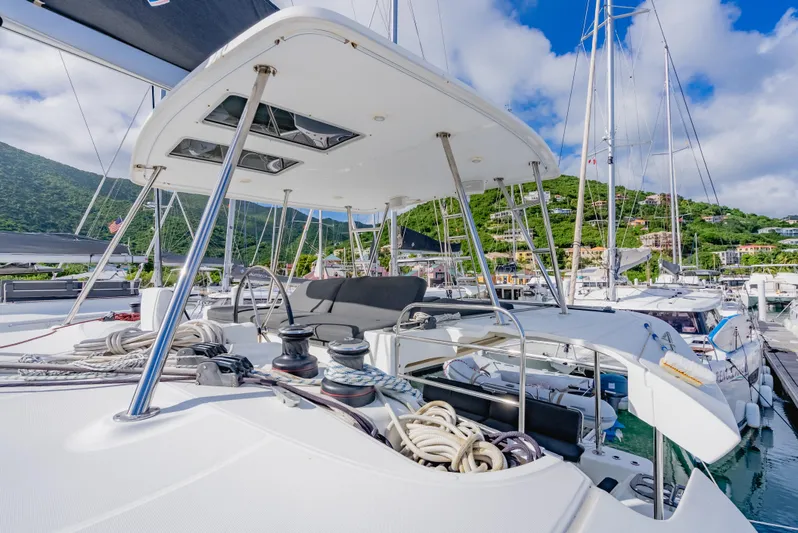 As You Wish Yacht Photos Pics 2020 Lagoon 46 catamaran docked, featuring spacious deck and lush green hillside backdrop.
