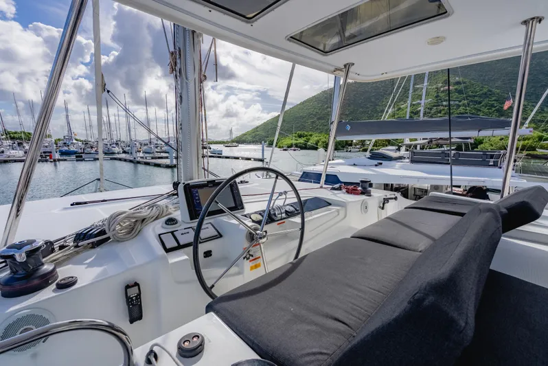 As You Wish Yacht Photos Pics Cockpit of 2020 Lagoon 46 catamaran docked in a marina with scenic mountain view.