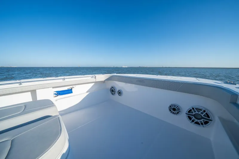 Catallac Yacht Photos Pics 2023 Invincible 46 Catamaran deck with ocean view, featuring seating and speakers.