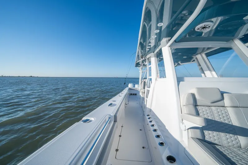 Catallac Yacht Photos Pics 2023 Invincible 46 Catamaran cruising on open water under clear blue skies.