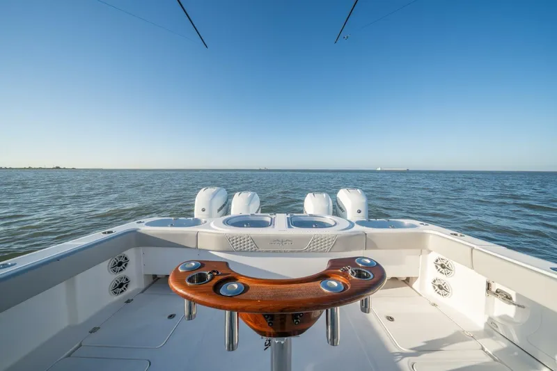 Catallac Yacht Photos Pics 2023 Invincible 46 Catamaran on open water, showcasing fishing setup and engines.