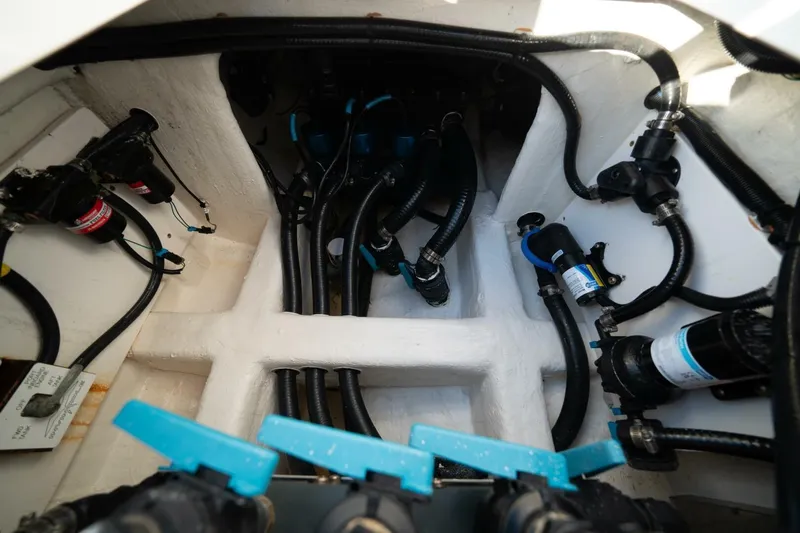 Catallac Yacht Photos Pics Engine compartment of 2023 Invincible 46 Catamaran, showcasing intricate wiring and plumbing.