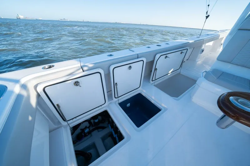 Catallac Yacht Photos Pics 2023 Invincible 46 Catamaran deck with open storage compartments, ocean view.