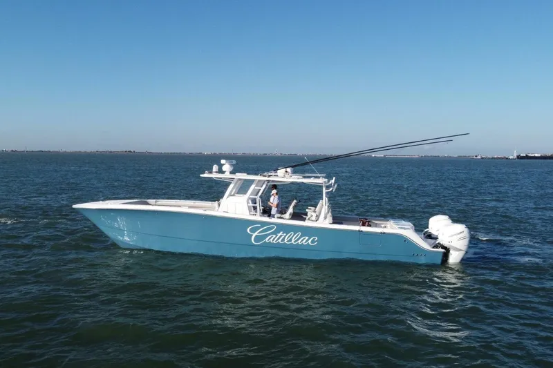 Catallac Yacht Photos Pics 2023 Invincible 46 Catamaran cruising on open water under clear blue skies.