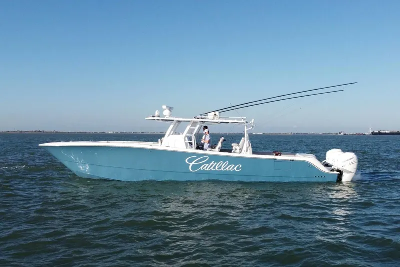 Catallac Yacht Photos Pics 2023 Invincible 46 Catamaran cruising on open water under clear blue skies.