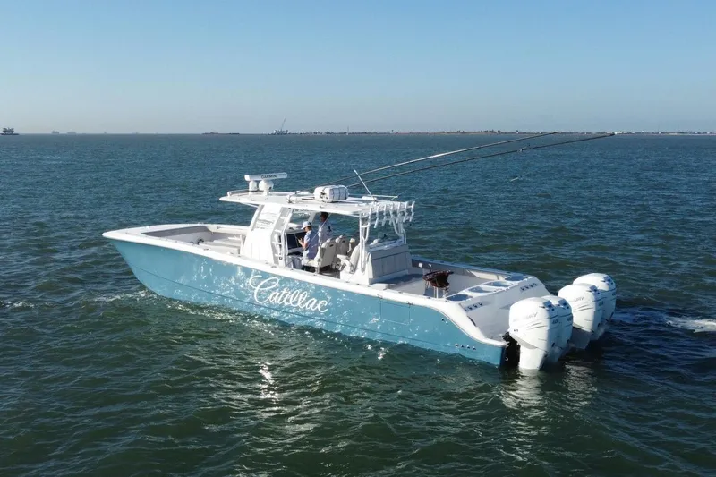 Catallac Yacht Photos Pics 2023 Invincible 46 Catamaran cruising on open water with triple outboard engines.