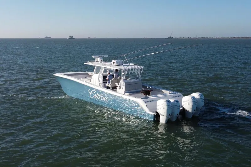 Catallac Yacht Photos Pics 2023 Invincible 46 Catamaran cruising on open water with multiple outboard engines.