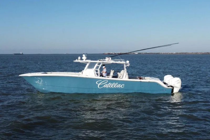 Catallac Yacht Photos Pics 2023 Invincible 46 Catamaran on open water, blue hull, multiple outboard engines.