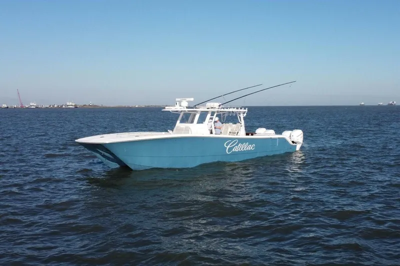 Catallac Yacht Photos Pics 2023 Invincible 46 Catamaran on open water, blue hull, clear sky.