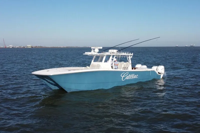 Catallac Yacht Photos Pics 2023 Invincible 46 Catamaran on open water, blue hull, clear sky.