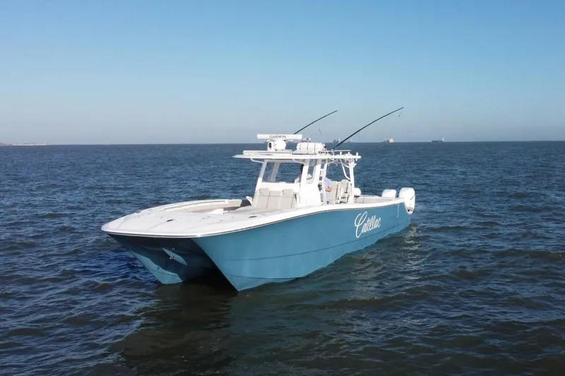 Catallac Yacht Photos Pics 2023 Invincible 46 Catamaran cruising on open water under clear blue skies.