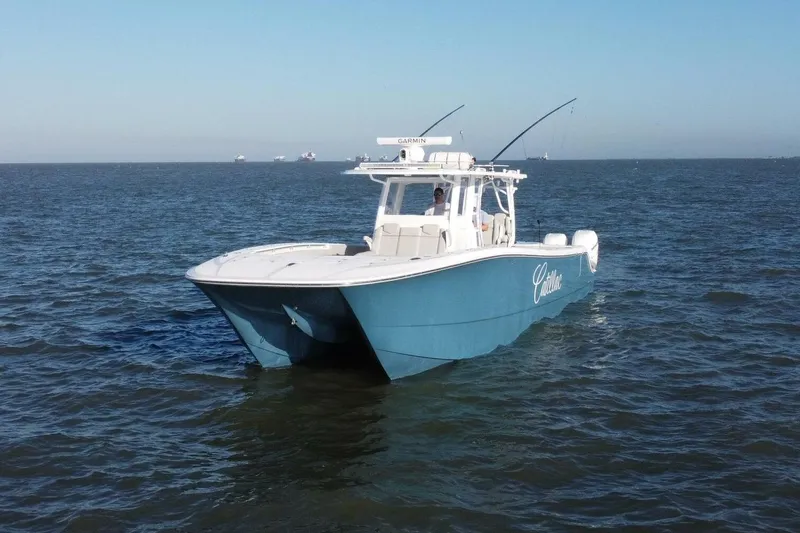 Catallac Yacht Photos Pics 2023 Invincible 46 Catamaran cruising on open water under clear skies.