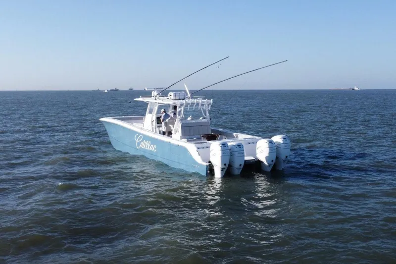 Catallac Yacht Photos Pics 2023 Invincible 46 Catamaran on open water, featuring multiple outboard engines.